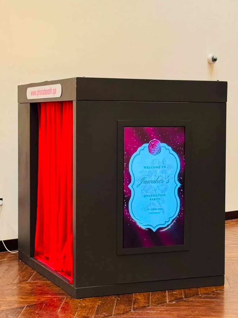 Prestige Box Photobooth with royal red curtain at a graduation in Doha